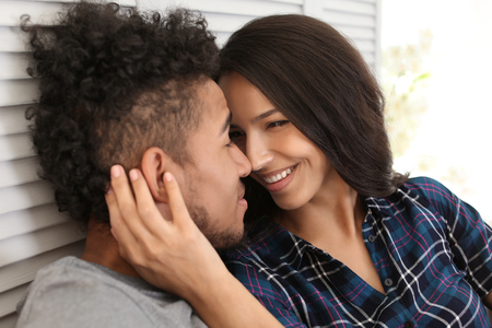 Happy African-American couple at homeの写真素材