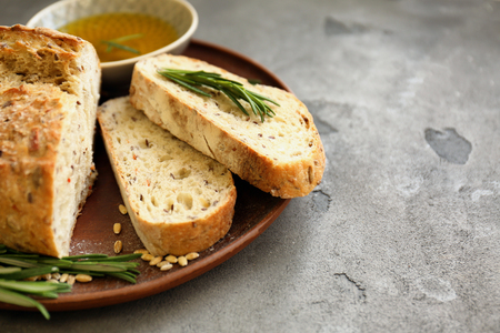 Plate with fresh tasty bread and oil on tableの写真素材