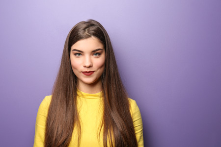 Young woman with beautiful hair on color background