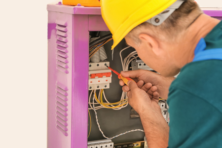 Electrician repairing distribution boardの写真素材
