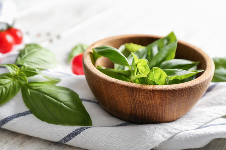 Bowl with fresh basil on tableの写真素材