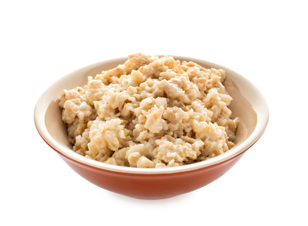Bowl with prepared oatmeal on white backgroundの写真素材