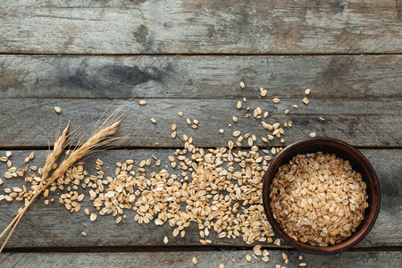 Composition with raw oatmeal on wooden backgroundの写真素材
