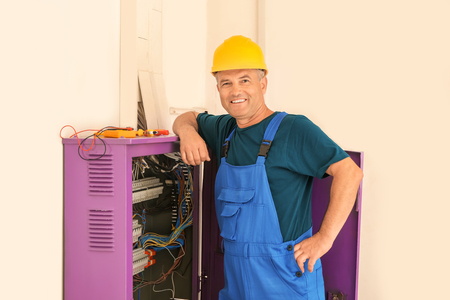 Mature electrician near distribution boardの写真素材