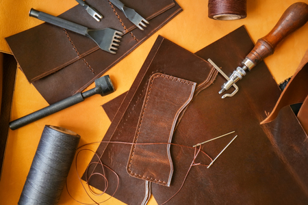 Leather and craft tools on table, top viewの写真素材