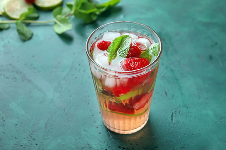 Glass with strawberry mojito on tableの写真素材