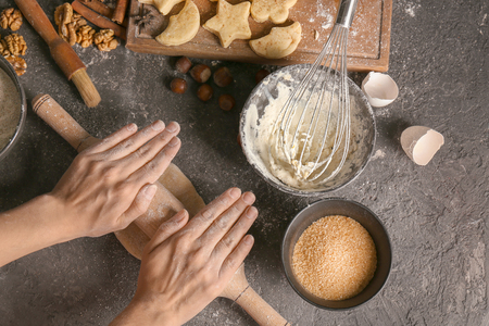 Woman rolling dough on grunge tableの写真素材