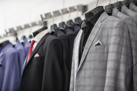 Holders with male clothes in boutiqueの写真素材