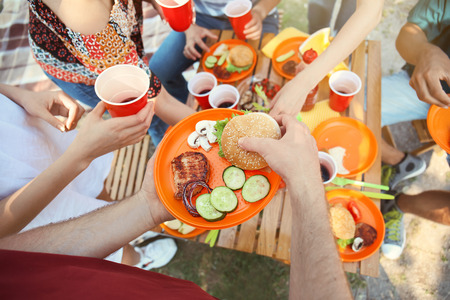 Young people having barbecue party outdoorsの写真素材