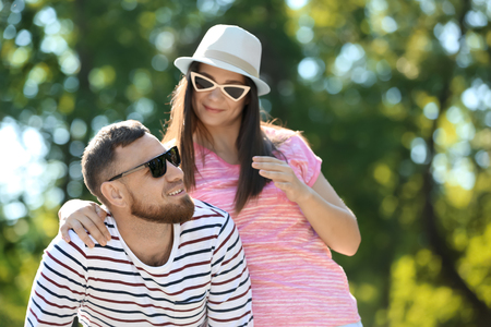 Happy couple in park on spring dayの写真素材