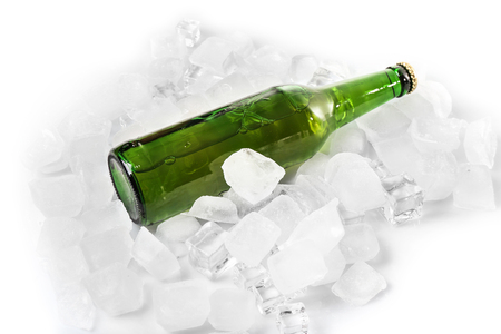 Bottle of beer in ice on white backgroundの写真素材
