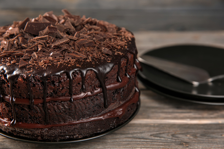 Plate with delicious chocolate cake on wooden table, closeupの写真素材
