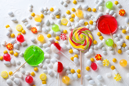 Colorful lollipops with marshmallows on light textured backgroundの写真素材