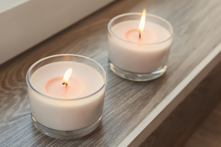 Burning wax candles on windowsillの写真素材
