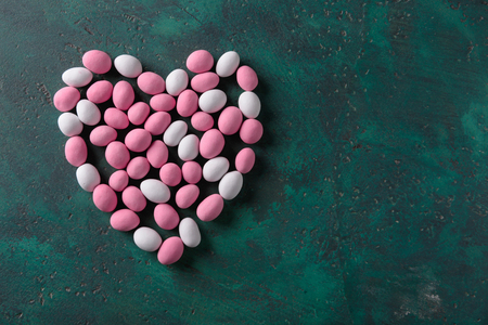 Heart made of color candies on textured backgroundの写真素材