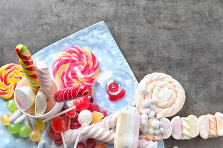 Colorful candies with marshmallows on grey backgroundの写真素材