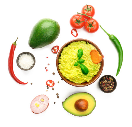 Bowl with tasty guacamole and ingredients on white backgroundの写真素材