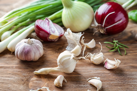 Fresh onions with garlic on wooden backgroundの写真素材