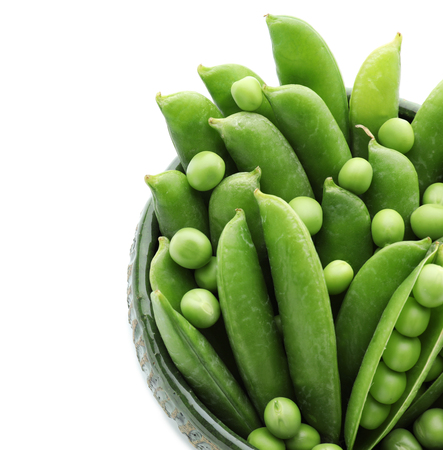 Bowl with green peas on white backgroundの写真素材