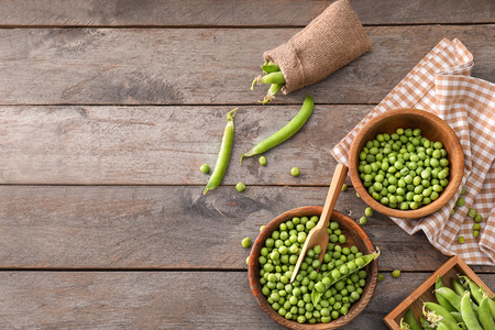 Composition with delicious fresh green peas on wooden tableの写真素材