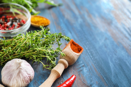 Various spices with herbs on wooden background