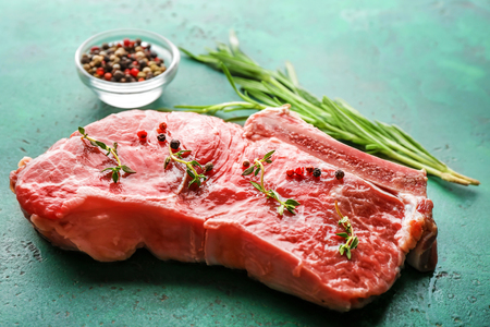Fresh raw meat with spices and herbs on tableの写真素材