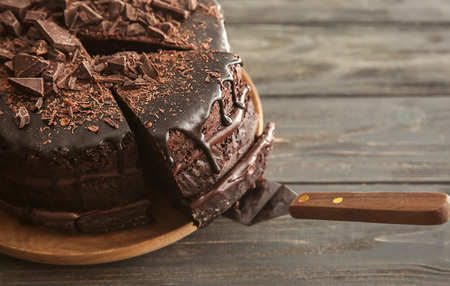 Plate with delicious chocolate cake on wooden table, closeupの写真素材