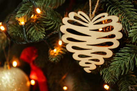 Glowing lights with wooden toy on Christmas treeの写真素材