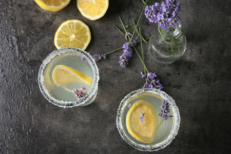 Glasses with tasty lavender lemonade on dark grey backgroundの写真素材