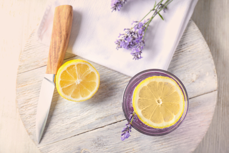 Wooden board with fresh lavender lemonade in glass on tableの写真素材