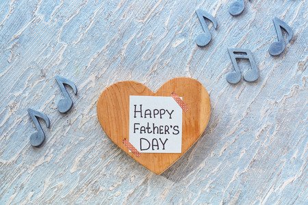 Heart with words HAPPY FATHERS DAY on wooden background