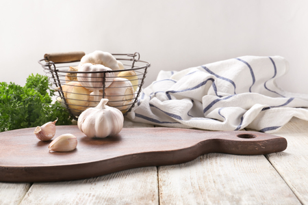 Composition with fresh garlic on light wooden tableの写真素材