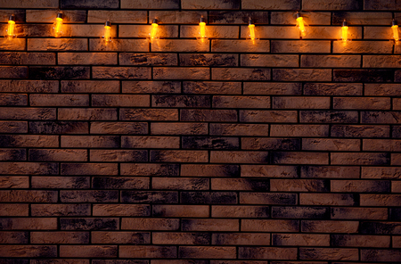 Festive Christmas garland on brick wallの写真素材