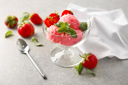 Dessert bowl with delicious strawberry ice-cream on grey backgroundの写真素材
