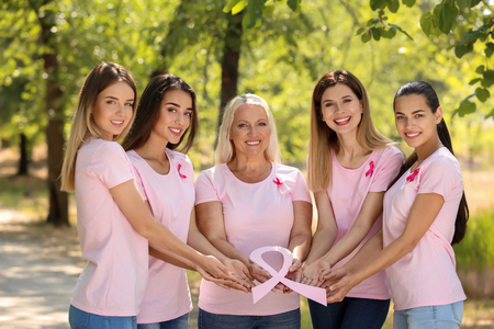 Beautiful women of different ages holding pink ribbon outdoors. Breast cancer conceptの写真素材