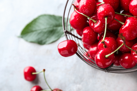 Basket with tasty ripe cherries on grey background, closeupの写真素材