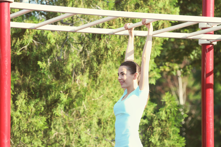 Beautiful young woman training outdoors