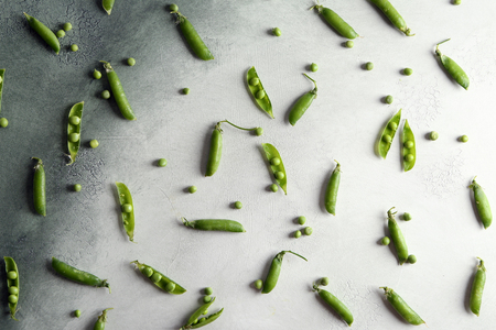 Fresh green peas on light table