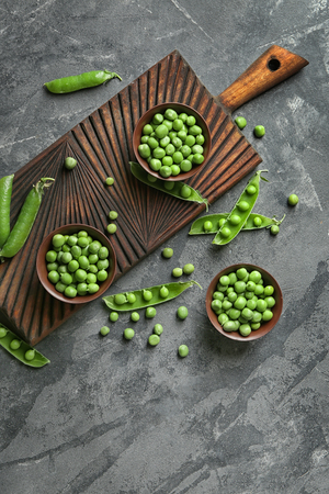 Composition with green peas on grey tableの写真素材