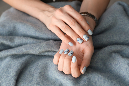 Young woman showing beautiful manicure on blanket, closeupの写真素材