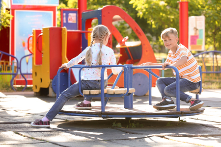 Cute little children outdoors on playgroundの写真素材