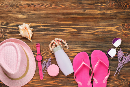 Composition with sunscreen and female accessories on wooden backgroundの写真素材