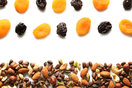 Composition with different nuts and dried fruits on white backgroundの写真素材
