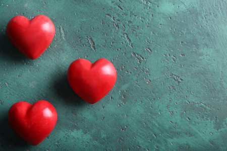 Red hearts on green backgroundの写真素材