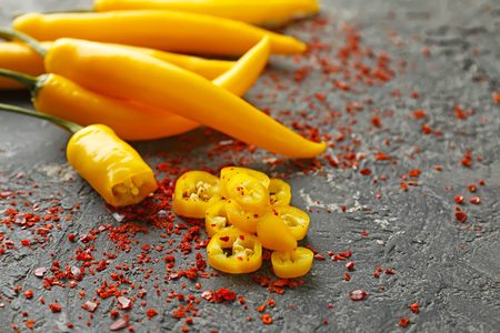 Fresh and dried chili peppers on grey textured backgroundの写真素材