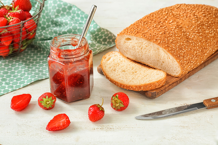 Composition with strawberry jam and bread on wooden tableの写真素材