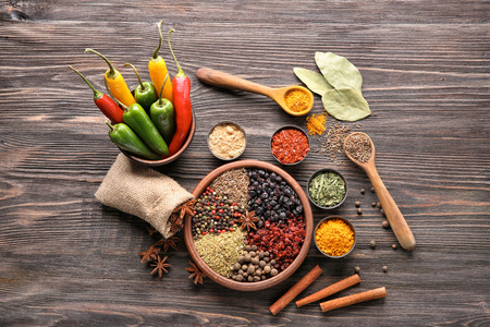 Composition with different dry spices on wooden backgroundの写真素材