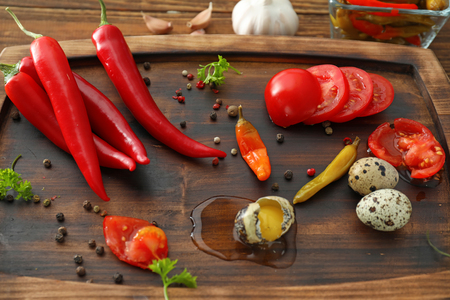 Composition with fresh chili peppers on wooden boardの写真素材