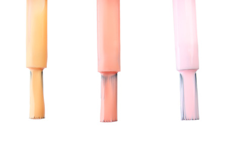 Brushes with colorful nail polishes on white backgroundの写真素材