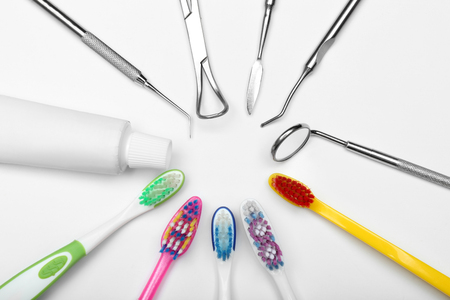 Set of dentist's tools, toothbrushes and paste on white backgroundの写真素材